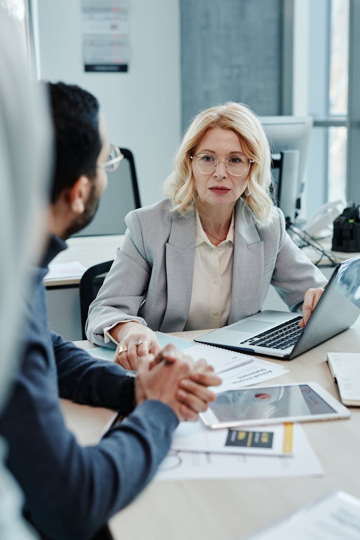 about-02 Caucasian woman leading a business meeting in a modern office setting.
