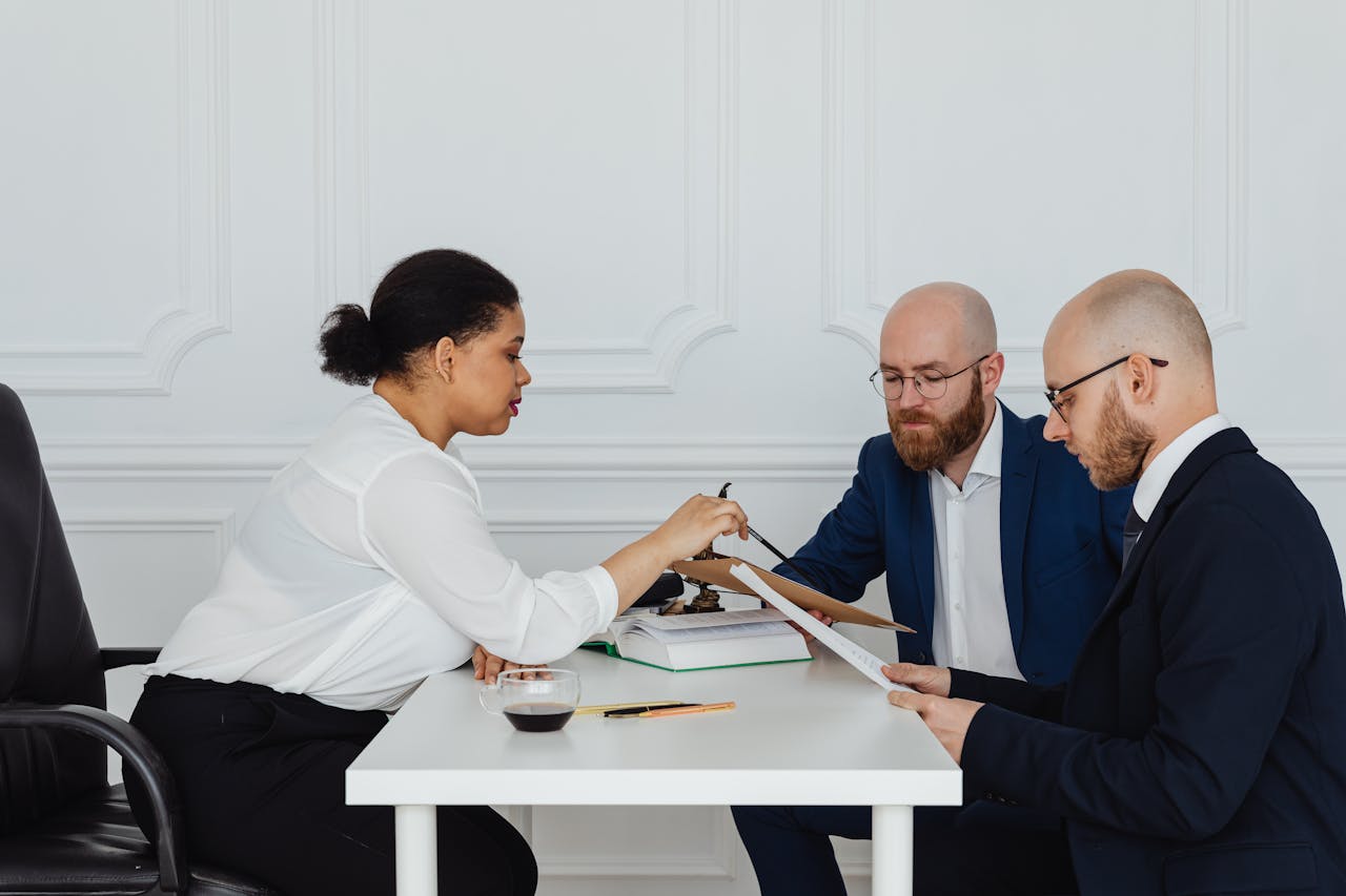 Business team discussing documents around table in office for project development.